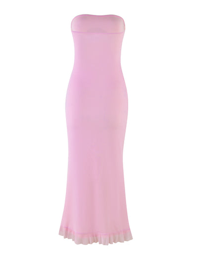 The LILLIAN DRESS - PINK from TIGERMIST is showcased against a plain white background. The strapless, floor-length dress, in baby pink with a subtle floral print, is form-fitting and flares out slightly at the bottom with a ruffled hem, creating an elegant mermaid silhouette. The fabric looks smooth and lightweight.