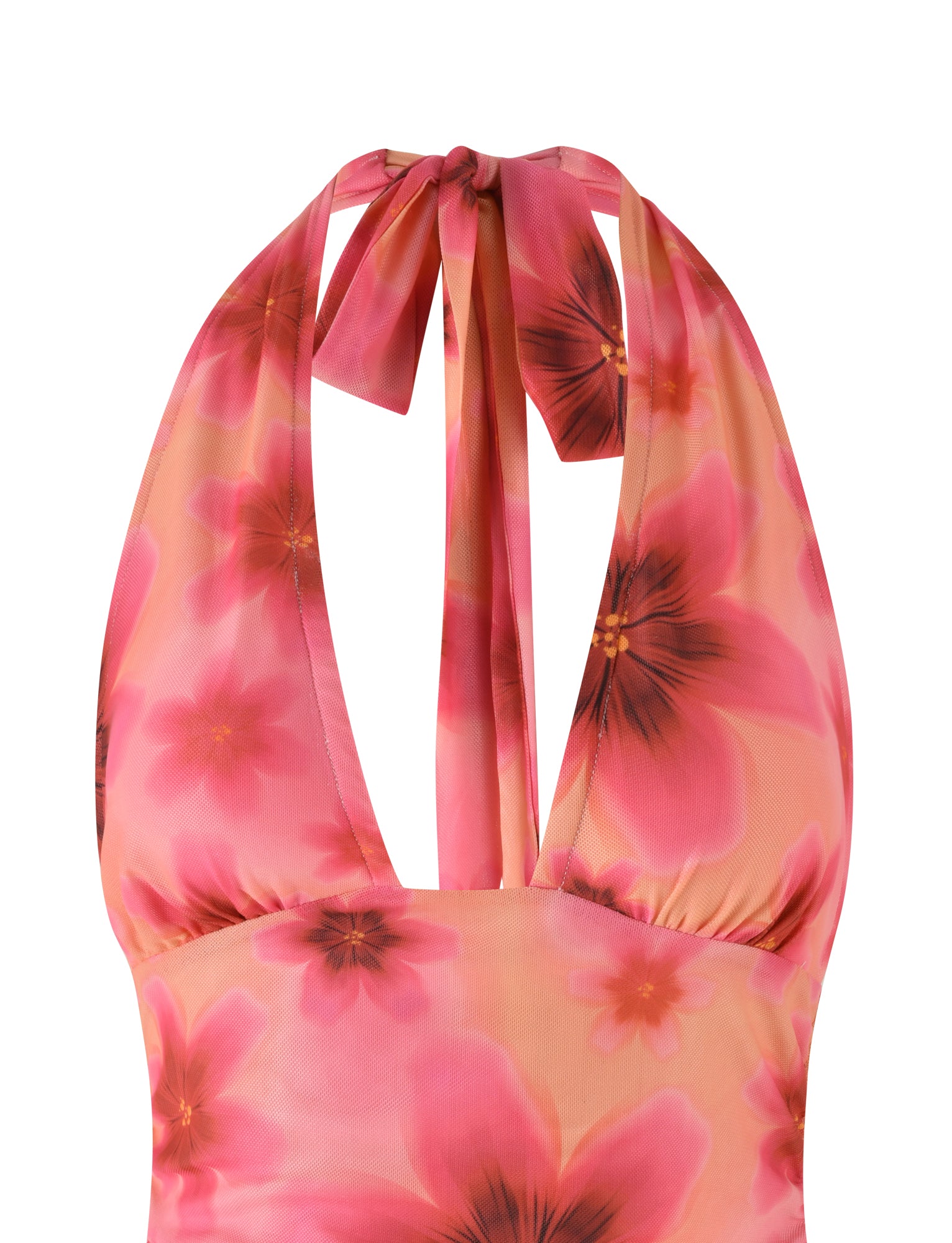 A close-up of the TIGERMIST FRANCIS TOP - MULTI : OMBRE : FLORAL, showcasing a halter neck design with large pink flowers that have darker centers on a peach background. The top features ties at the back of the neck and is made from lightweight mesh fabric, making it perfect for warm weather.