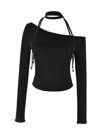 The MIETTA TOP - BLACK by TIGERMIST is a chic, black, long-sleeve top with an asymmetric off-shoulder design and a distinctive multi-tie neck detail featuring two long strings that elegantly drape down the front. The high-stretch fabric ensures a fitted look, while the sleeves are enhanced with subtle ruffled hems.