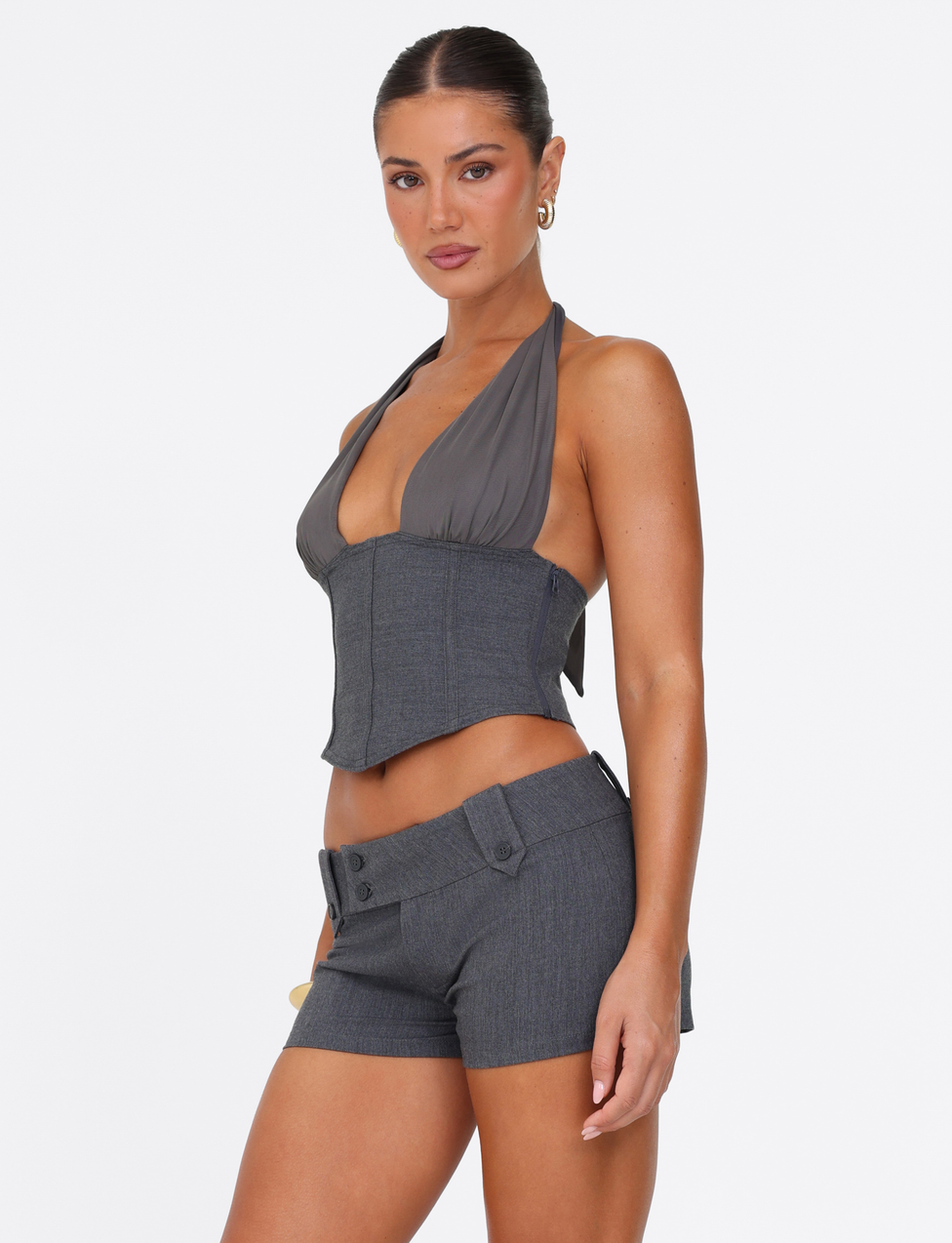 A woman wears the TIGERMIST KITTIE SHORT - GREY with a matching halter-neck gray crop top, posing against a plain white background.