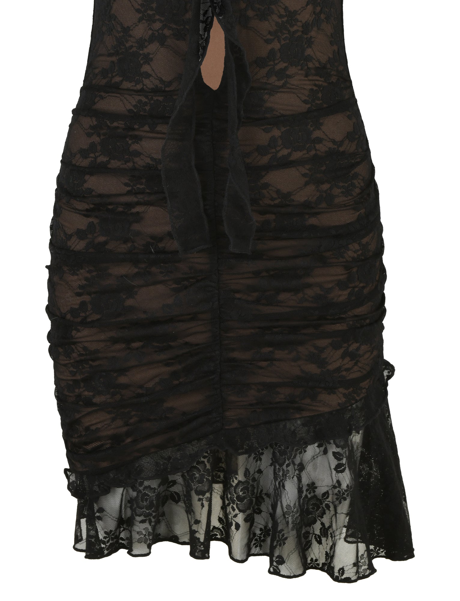 A detailed close-up of the TIGERMIST CARLY LACE DRESS - BLACK reveals its semi-transparent fabric and ruffled edges at the hem. The intricate floral pattern is enhanced by ruched stitching throughout, with a black satin ribbon elegantly tied at the center near the top of the image.