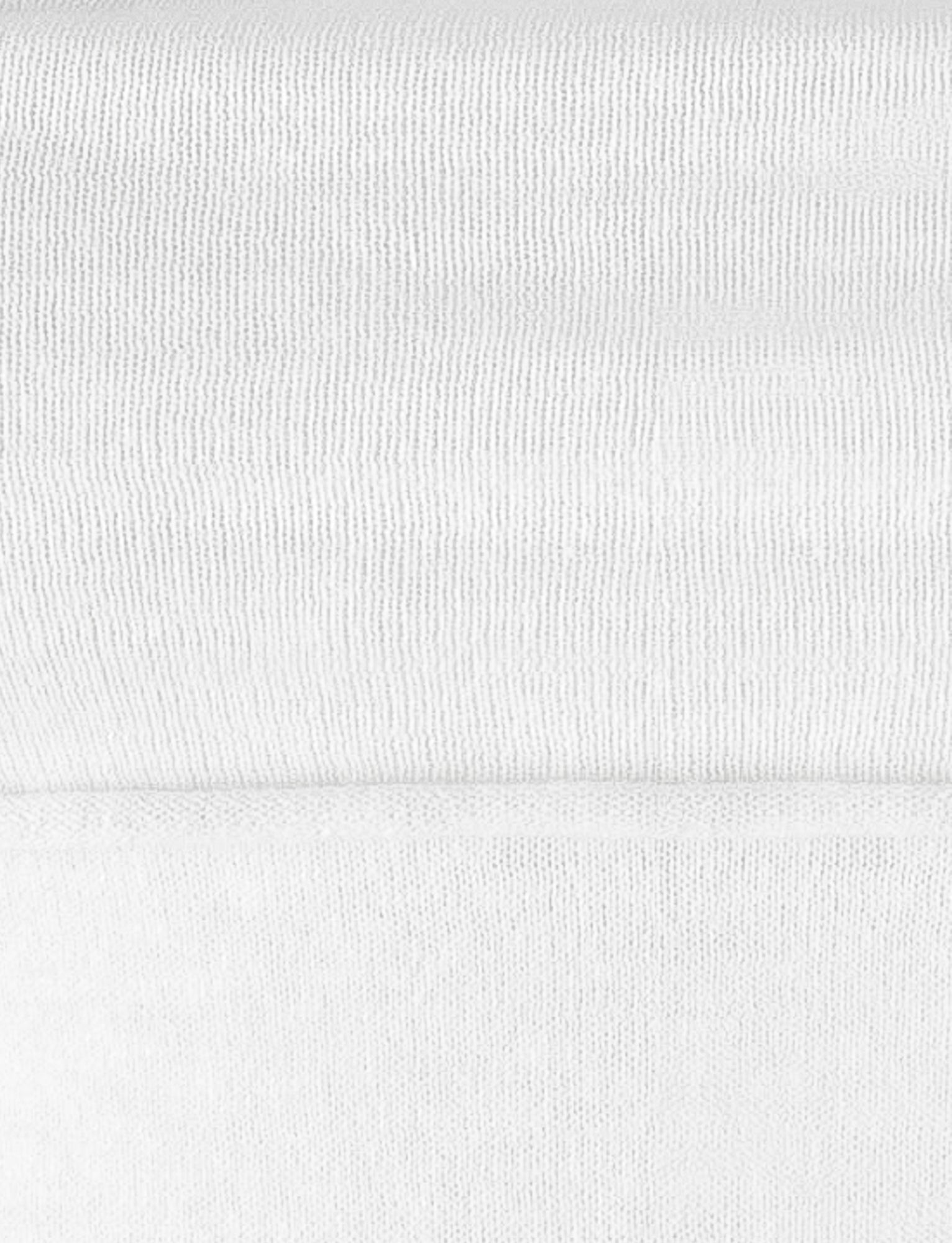 A close-up image showcasing the texture of a high stretch, neatly folded white knit fabric. The fabric has a horizontal seam at the fold, forming a delicate line across the middle of the image. The texture appears soft and subtly ribbed, bringing to mind the elegant structure of TIGERMIST's DIEDRE JUMPER - WHITE : CREAM.