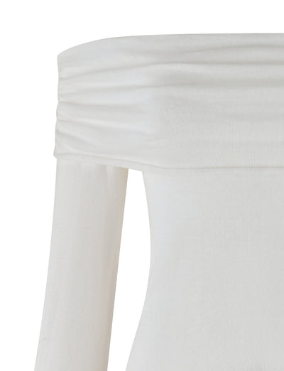 The DIEDRE JUMPER - WHITE : CREAM from TIGERMIST is highlighted, emphasizing its off-the-shoulder white neckline. The jumper dress includes a ruched, fold-over detail at the neckline and has long sleeves. Made from high stretch fabric, the material feels soft and lightweight.