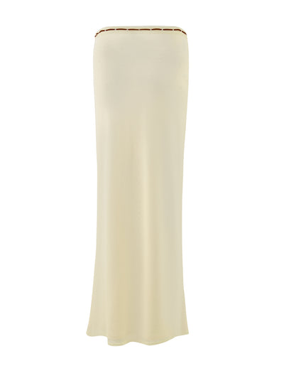 The FENNEL SKIRT in a pale yellow shade by TIGERMIST offers a strapless and slightly flared design, complete with lace trim around the top edge. Made from high-stretch fabric, it provides comfort while maintaining a simple and elegant appearance.