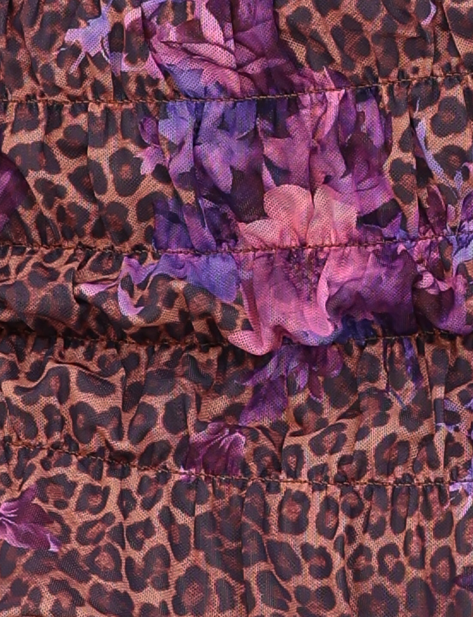 Close-up of the TIGERMIST HOLLIS SKORT in Neutral Floral Leopard print, showing ruched stitching, elasticated shirring, and a playful mix of brown, black, purple, and pink—perfect for a super mini skort.