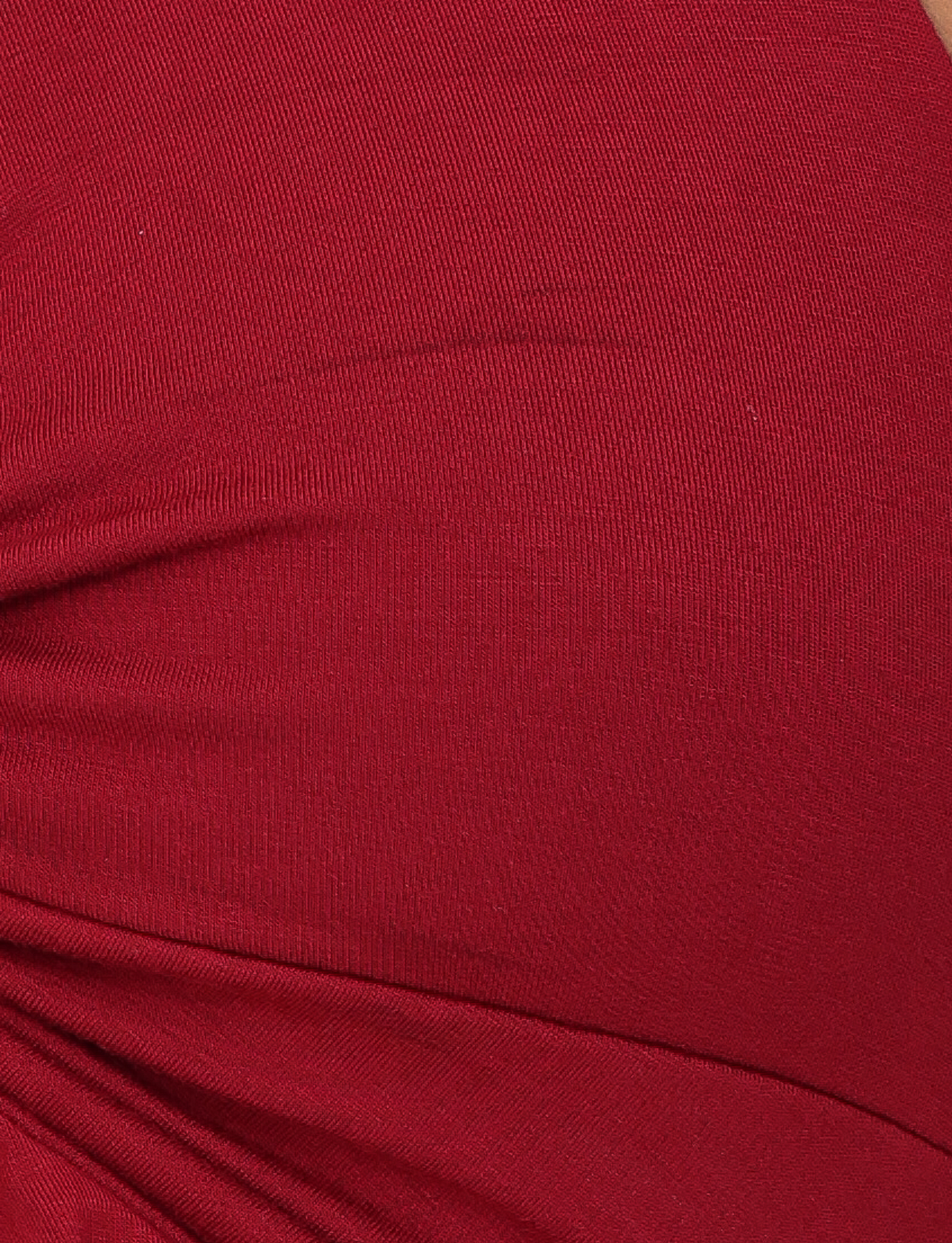 Close-up of the TIGERMIST KATYA HALTER TOP in red, highlighting its visible seam and ruched details that create textured folds.
