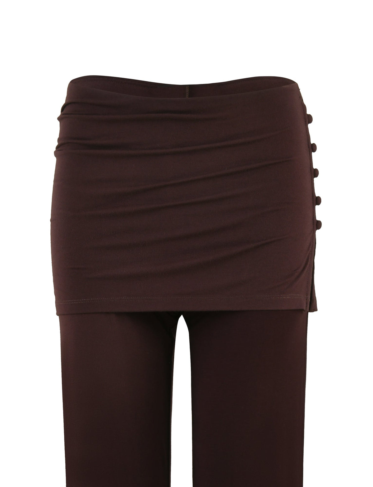 The LEILANI PANT - BROWN : CHOCOLATE by TIGERMIST is a stylish pair of pants featuring a flared leg and an attached wraparound skirt at the waist with side button detailing on the right. The high-stretch fabric of the ruched-texture skirt adds a fashionable touch to the design.