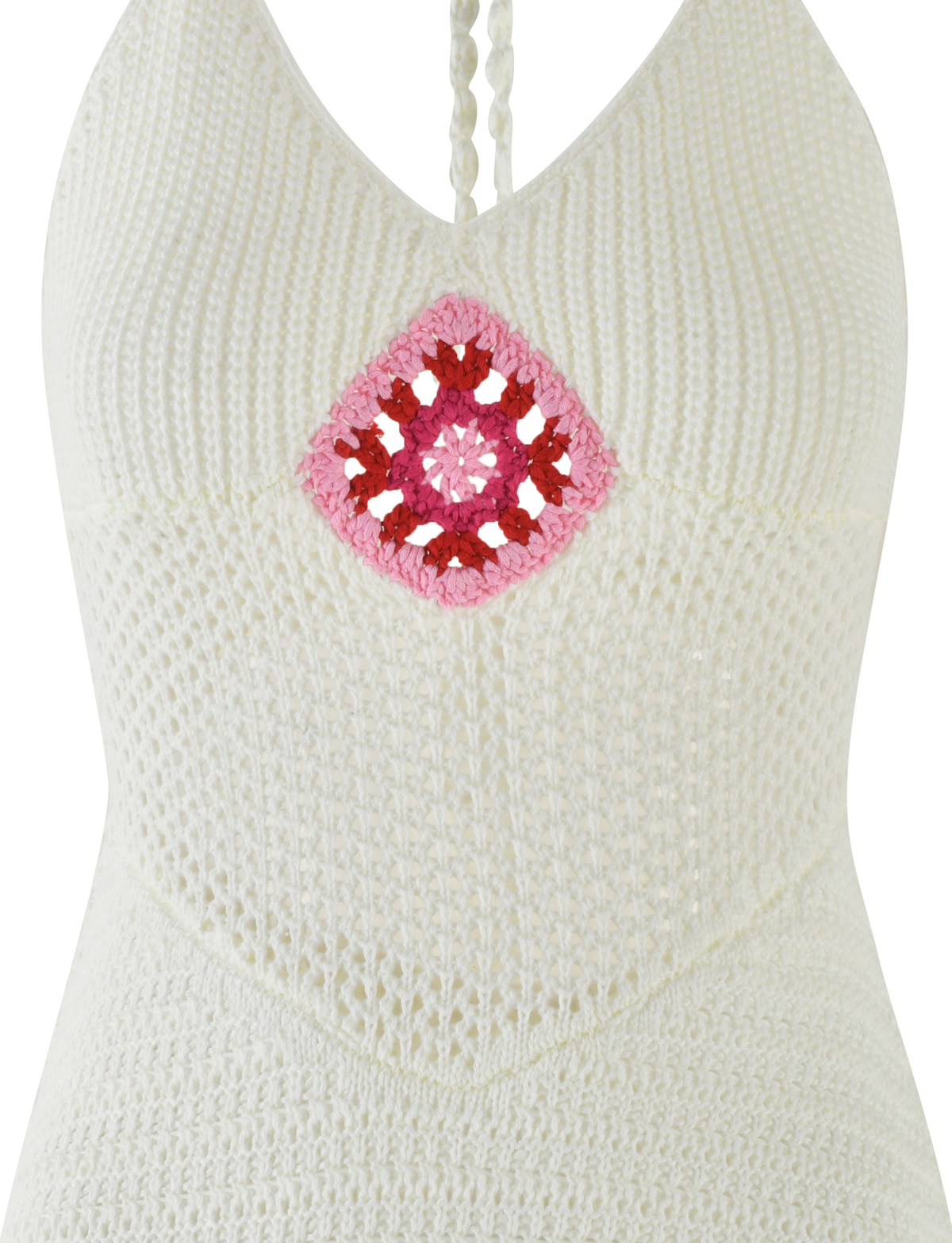Close-up of the TIGERMIST TENZIN MINI DRESS in cream, a crochet mini dress with a pink and red diamond Granny Square at the chest, textured crochet fabric, and a stylish halter neckline.