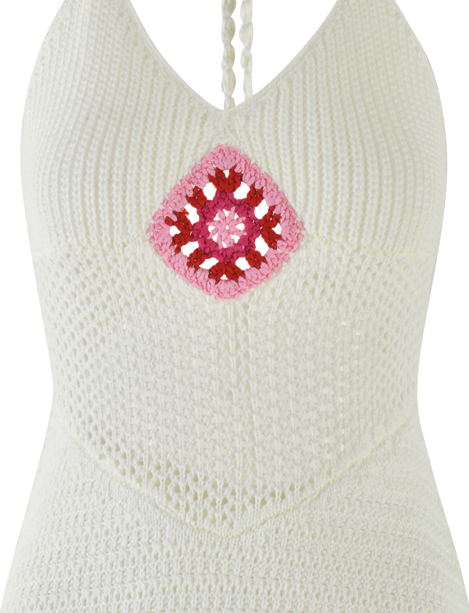 Close-up of the TIGERMIST TENZIN MINI DRESS in cream, a crochet mini dress with a pink and red diamond Granny Square at the chest, textured crochet fabric, and a stylish halter neckline.