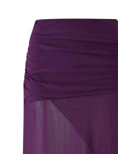 A close-up of the TIGERMIST MARIANA SKIRT - PURPLE shows ruched waist detailing, an asymmetric wrap hemline, and lightweight sheer fabric with a slightly transparent finish.