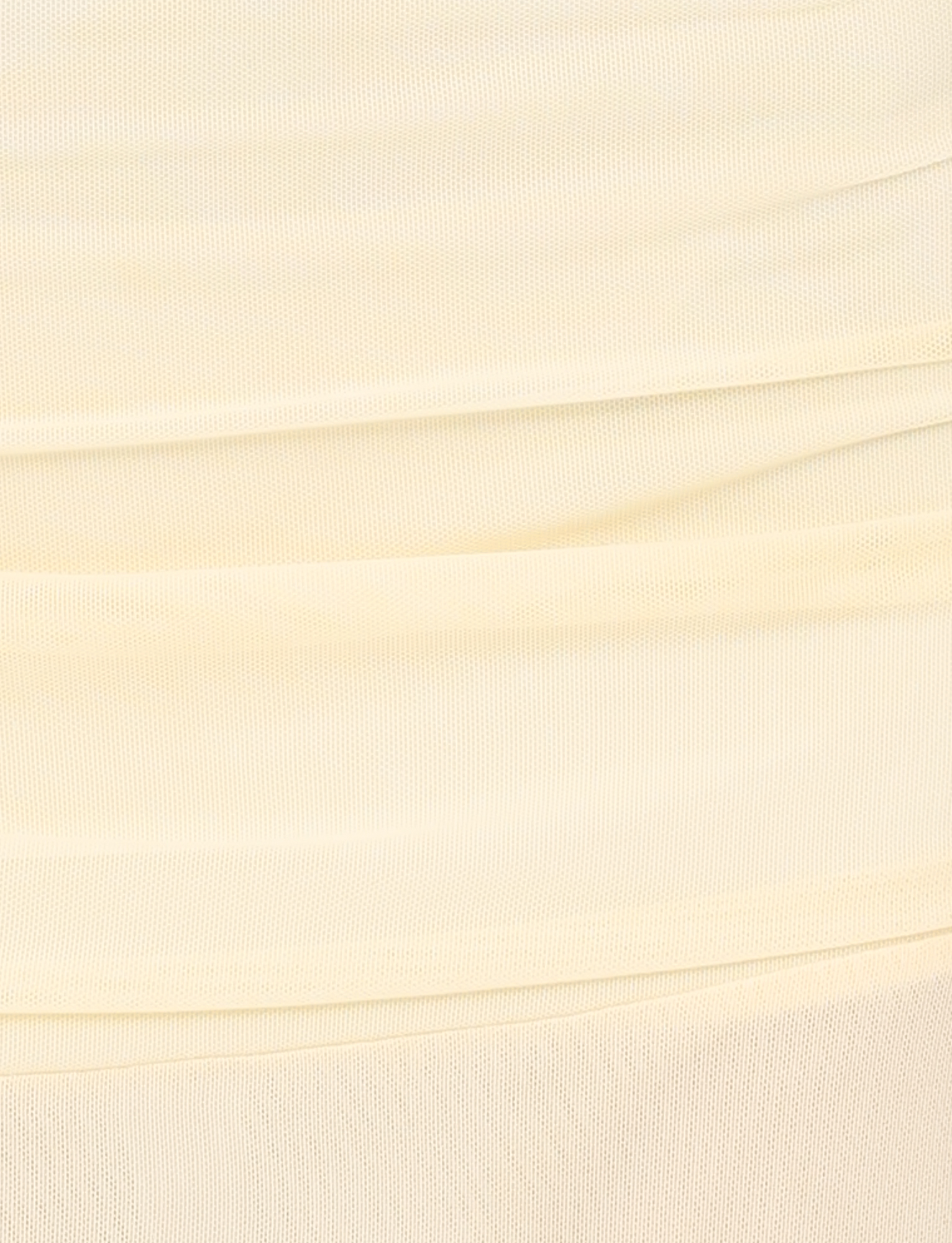 Close-up of the TIGERMIST MARIANA SKIRT in pale yellow, featuring soft mesh fabric with horizontal gathered folds and a textured surface—lightweight and perfect for an airy midi style with subtle shading and lines.