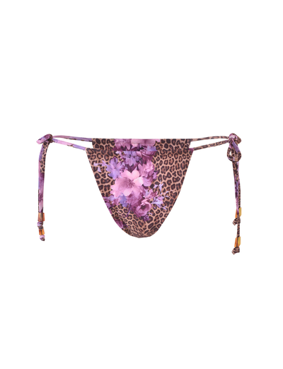 The DESIRAE BIKINI BOTTOM by TIGERMIST features a purple floral leopard print and adjustable side ties with wooden beads for a customizable fit.