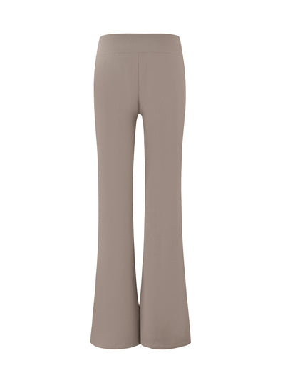 A pair of VESPER PANT - BROWN : TAN from TIGERMIST is shown. The solid tan, high-waisted flare pants have a smooth, seamless design with a wide waistband and a slightly flared leg, tailored for a sleek and stylish fit. The image captures the rear view of the fitted silhouette.