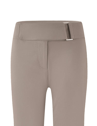 The VESPER PANT - BROWN: TAN by TIGERMIST, featuring a full-length silhouette and a low-rise waist, showcases a solid tan belt with a silver buckle. Displayed against a white background, the pants have visible belt loops, as well as zipper and button closure at the front.