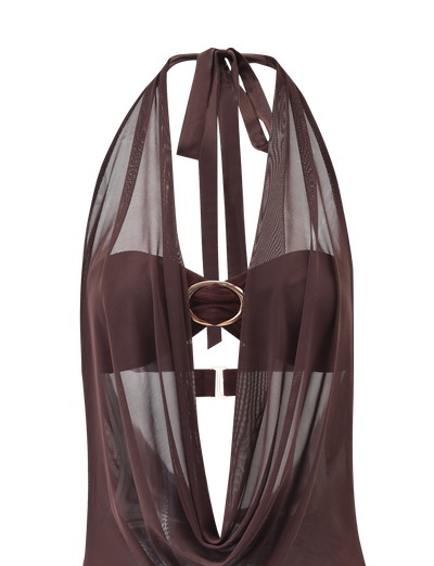 The MAKENA TWO-PIECE DRESS in chocolate by TIGERMIST features a brown mesh-inspired design with a halter neck, plunging neckline, sheer draped details, gold oval ring accent at the center, and a fabric strap tie at the neck.