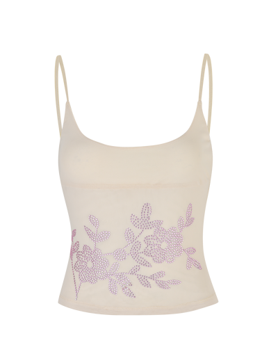 The OCTAVIA TOP - NEUTRAL : CREAM by TIGERMIST is a cream camisole with spaghetti straps, adorned with a lavender floral pattern across the lower front.