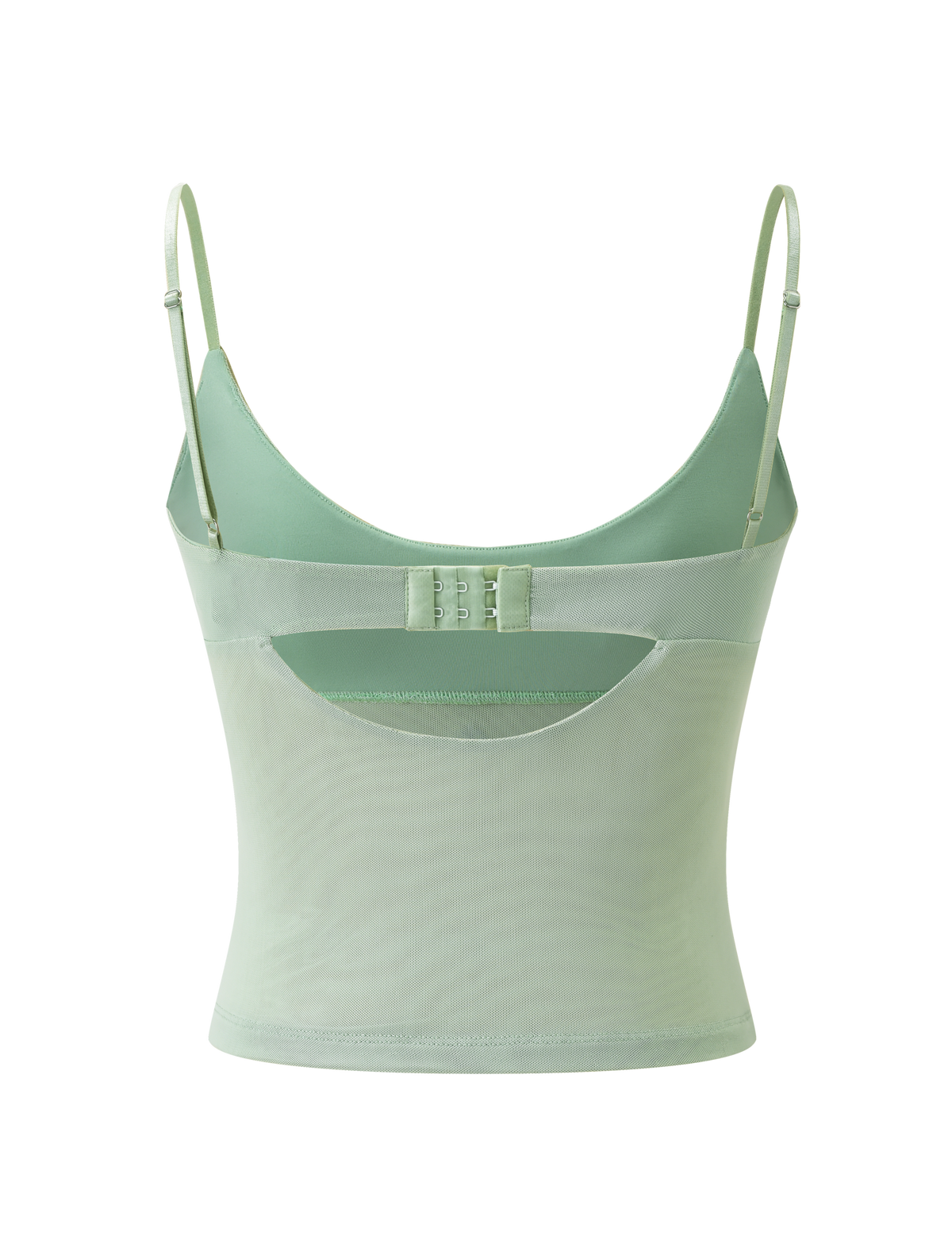 The OCTAVIA TOP - PISTACHIO by TIGERMIST is a pastel green camisole with adjustable thin straps, a scoop back, hook-and-eye closure, and a sheer mesh panel at the lower back.