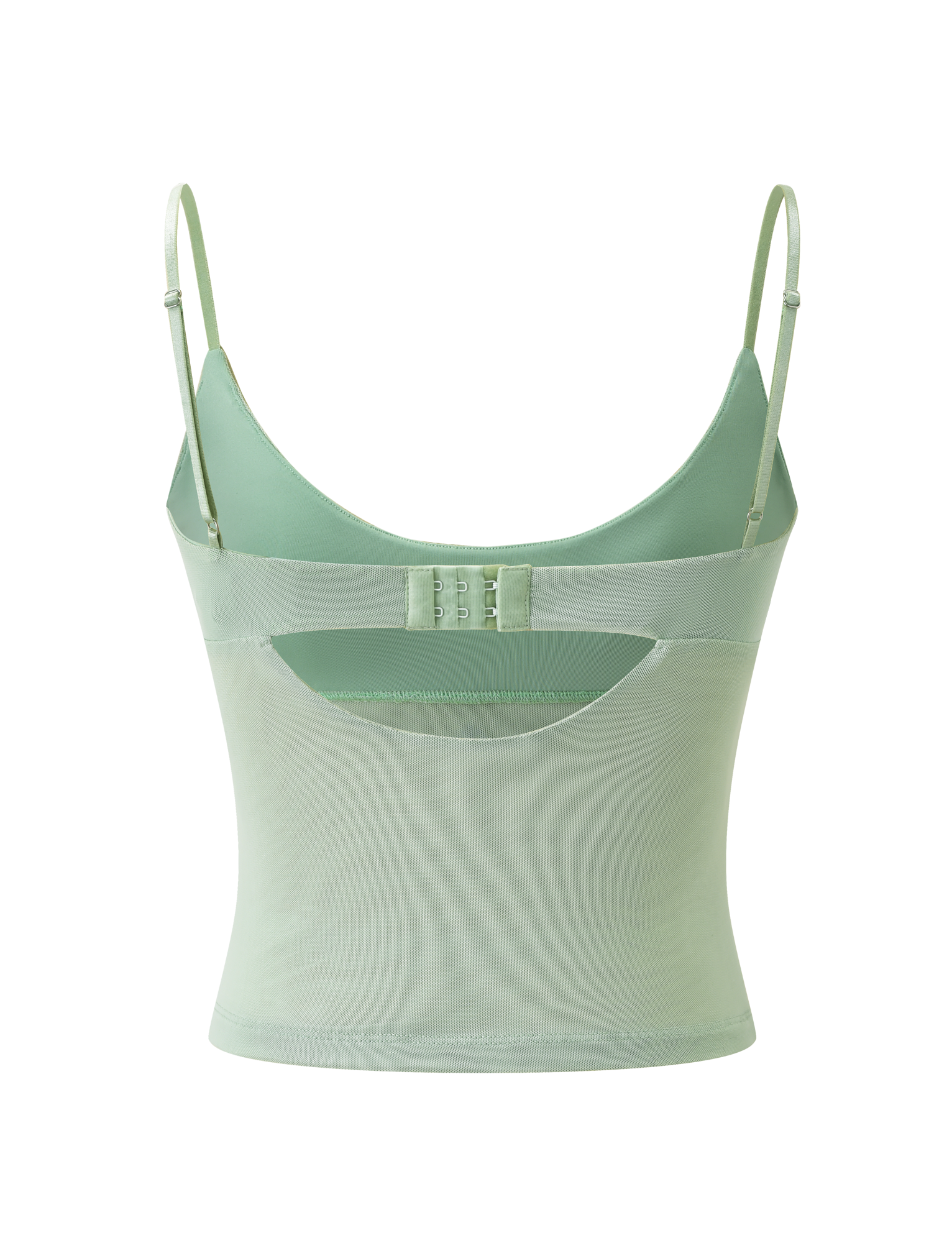 The OCTAVIA TOP - PISTACHIO by TIGERMIST is a pastel green camisole with adjustable thin straps, a scoop back, hook-and-eye closure, and a sheer mesh panel at the lower back.