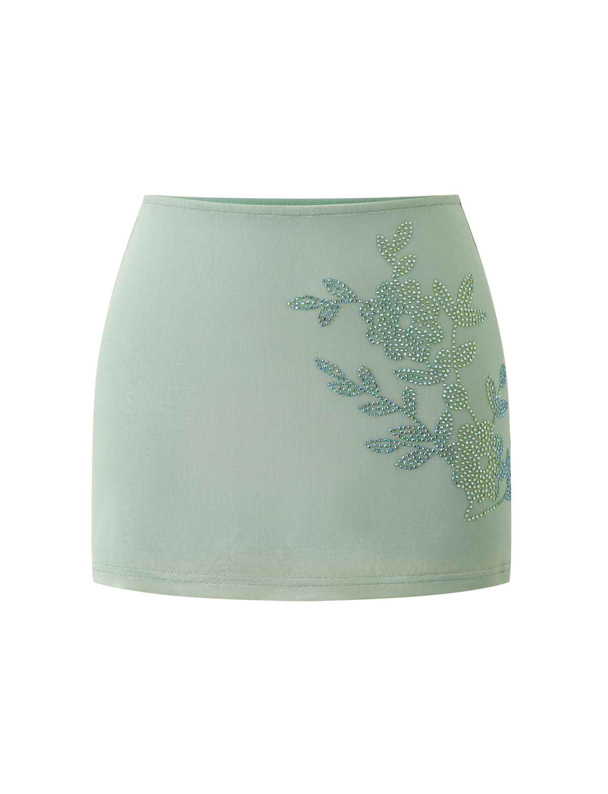 The TIGERMIST OCTAVIA MINI SKIRT in pistachio features a light green hue and rhinestone floral embellishment on one side, showcased against a plain white background.
