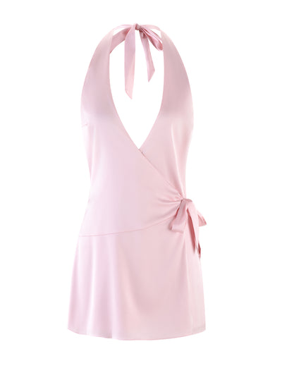 The MONROE 2.0 MINI DRESS - PINK in pastel pink by TIGERMIST is a sleeveless satin wrap dress featuring ribbon ties at the neck and waist, along with a plunging neckline for an elegant look.