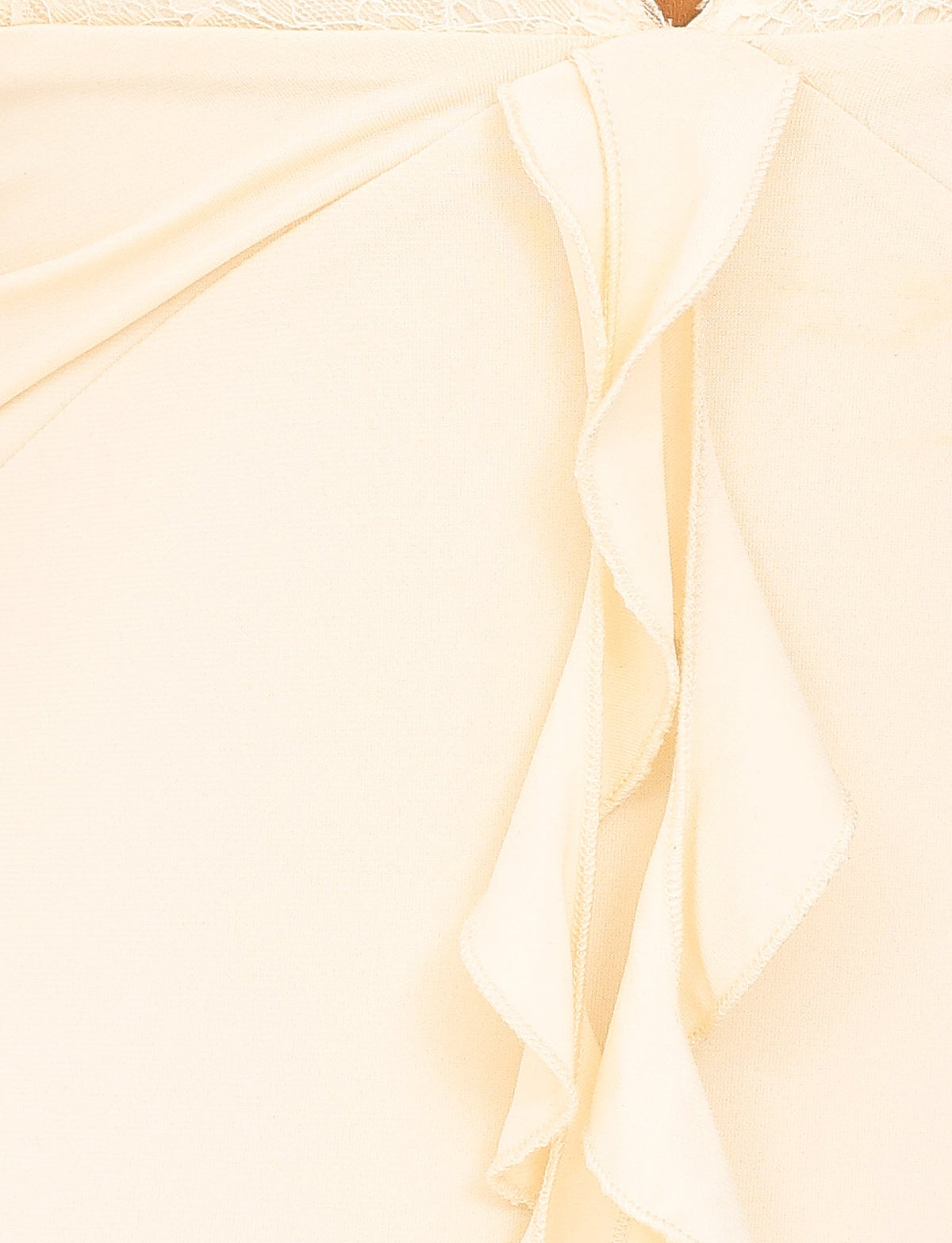 Close-up of the DEENA MAXI DRESS - YELLOW : LEMON by TIGERMIST, showcasing its light lemon fabric adorned with soft, flowing ruffles. The texture appears smooth and slightly sheer, offering a delicate and elegant appearance. Vertical ruffles accentuate the lace bust cups, enhancing the maxi length design's graceful allure.