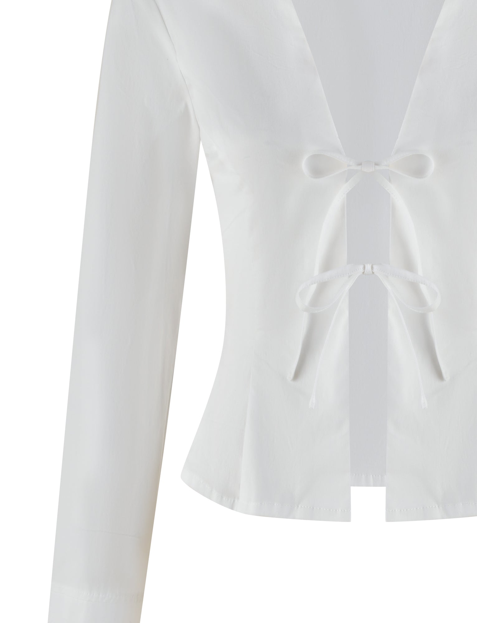 The TIGERMIST BRIELLE SHIRT in white/ivory is a long-sleeved, fitted blouse featuring a deep V-neckline, two decorative front bows, and a defined waist with a slight flare. Made from soft stretch fabric for a shiny appearance.