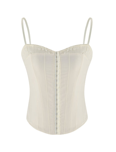 The ANTONELLA TOP by TIGERMIST in white, bone, or cream is a soft-touch suiting corset top with thin adjustable straps, vertical seams, and a structured, form-fitting silhouette.