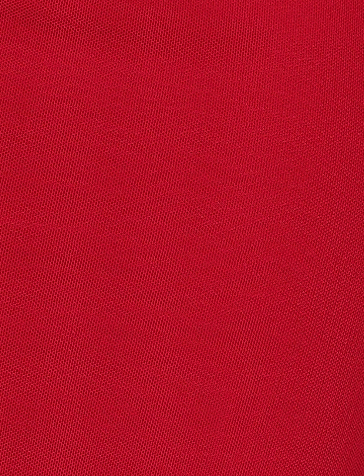 A close-up of the BRESILY MAXI DRESS - RED by TIGERMIST shows its fine, red textured fabric with a smooth, uniform weave—perfect for highlighting subtle embroidery or delicate halter straps.