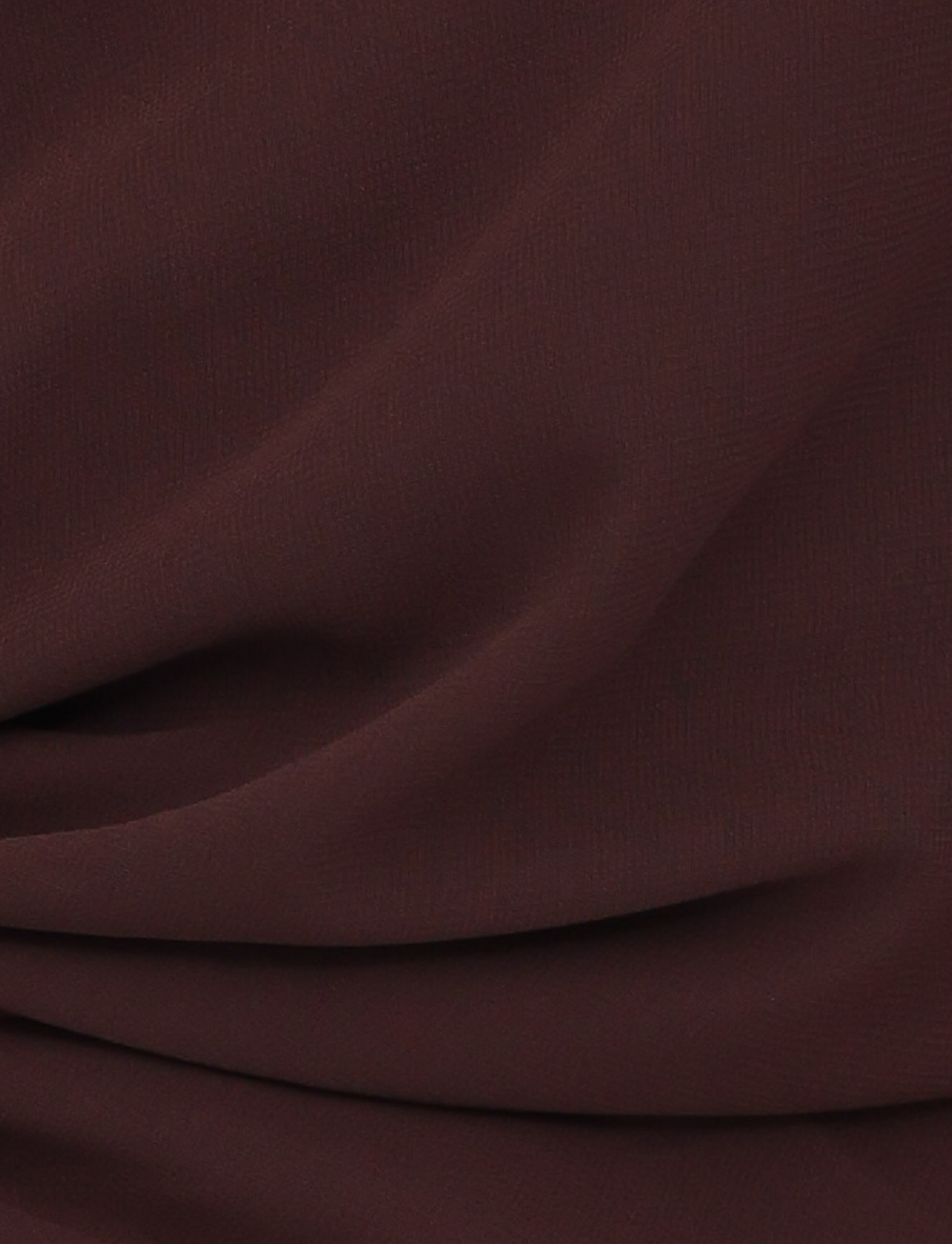 A close-up of the TIGERMIST INDIGO TOP - BROWN : CHOCOLATE shows its chocolate brown chiffon fabric with soft folds, subtle texture, and gentle shadows for a smooth, elegant look.