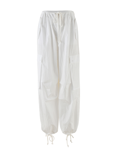 The TIGERMIST VIOLETTE PANT in white features an oversized fit, elastic drawstring waistband, large flap side pockets, and adjustable ankle drawstrings. Displayed on a plain white background.