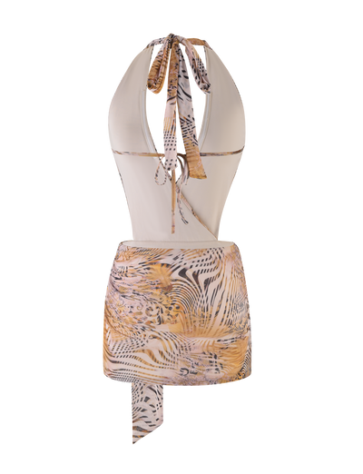 A back view of the TIGERMIST YARA MINI DRESS in Neutral Animal Marble, styled as a swimsuit and paired with an animal print sarong featuring beige, black, and gold tiger stripes tied at the waist.
