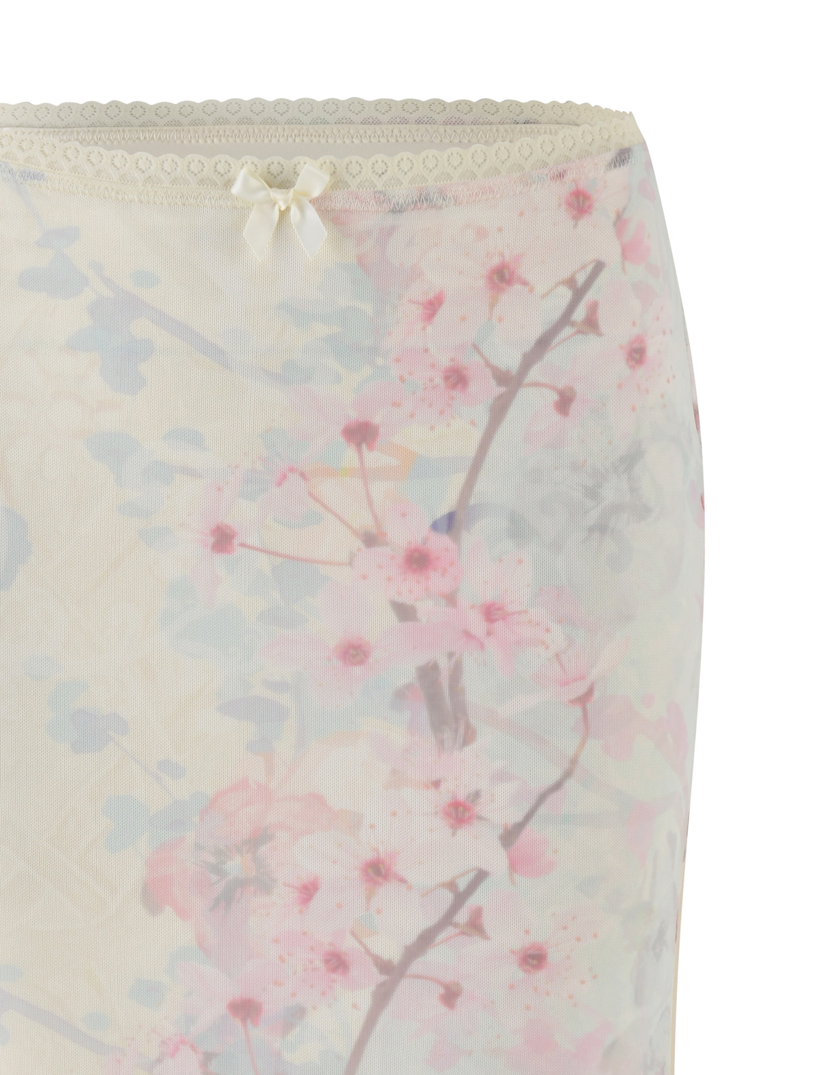 Close-up of the TIGERMIST LONIE MIDI SKIRT in Neutral, showcasing a washed cherry blossom floral print with lace trim and a satin bow—an exclusive design that pops against the white background.