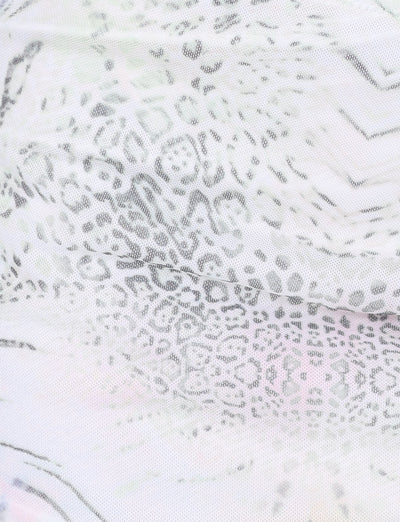 Close-up of the TIGERMIST JOSEPHINE MINI SKIRT in white animal print, featuring light semi-transparent fabric with a subtle leopard pattern—perfect for trendy mesh mini skirt styles or ruched side seam designs.