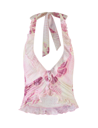 The DALILA TOP by TIGERMIST features a grunge floral magenta print, sleeveless halter design, deep V-neckline, front ruffle trim, gathered ruched center with decorative bows, and is crafted from high-stretch fabric for a flattering fit.