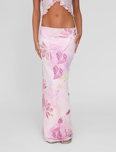 A person models the TIGERMIST DALILA MIDI SKIRT in Grunge Floral Magenta, showcasing only their lower torso and legs against a plain light gray background.