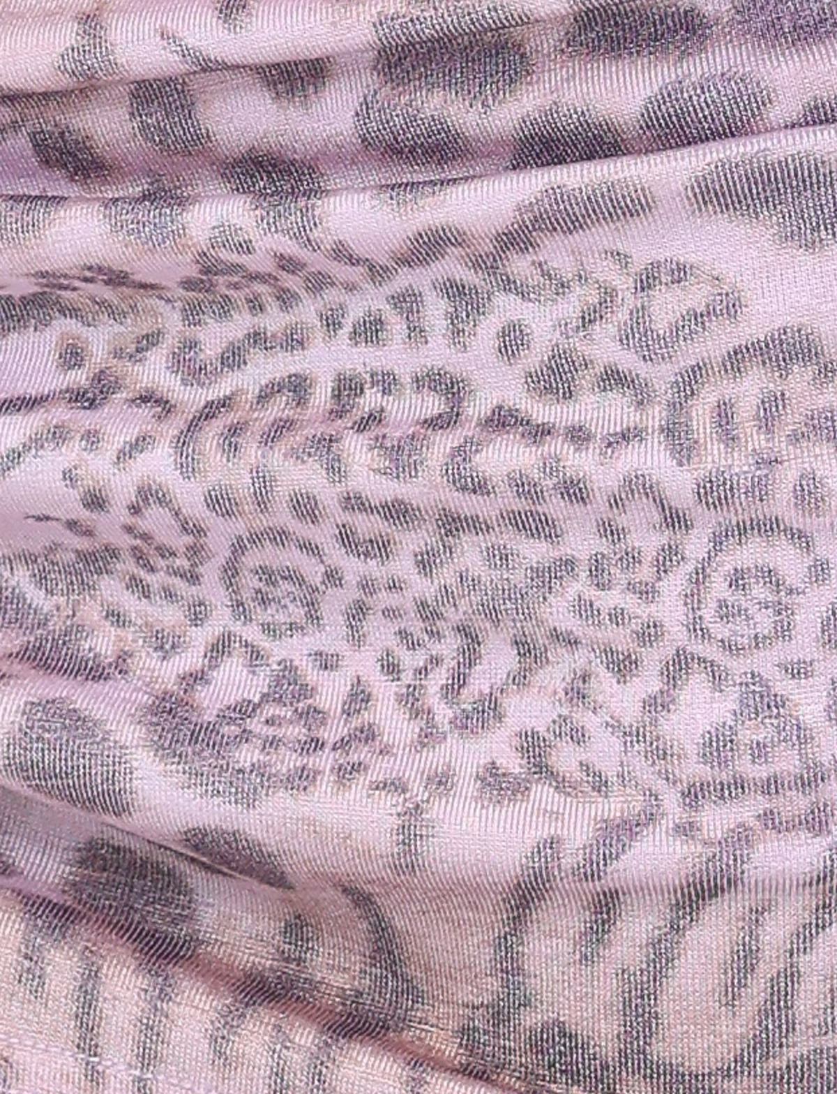 Close-up of the EVANGELINE SKIRT - PINK : TIGER by TIGERMIST, featuring pale pink fabric with a textured gray and purple tiger print—slightly sheer with soft folds, perfect for adding a trendy twist to your look.