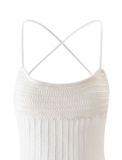 The EMELYN TOP - CREAM by TIGERMIST features thin spaghetti straps that crisscross into a lace-up back, a textured ribbed fabric, and a softly curved neckline for an elegant look.