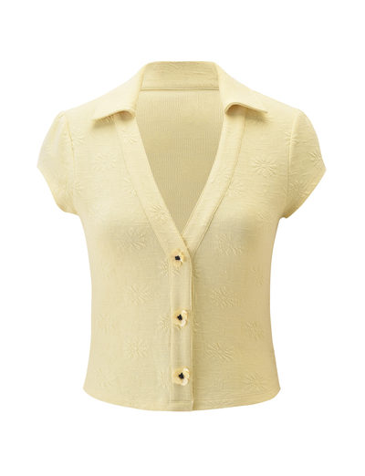 The QUINLAN TOP - LEMON by TIGERMIST features cap sleeves, a collared deep V-neckline, four front buttons, and subtle embossed floral details. Shown against a plain white background.