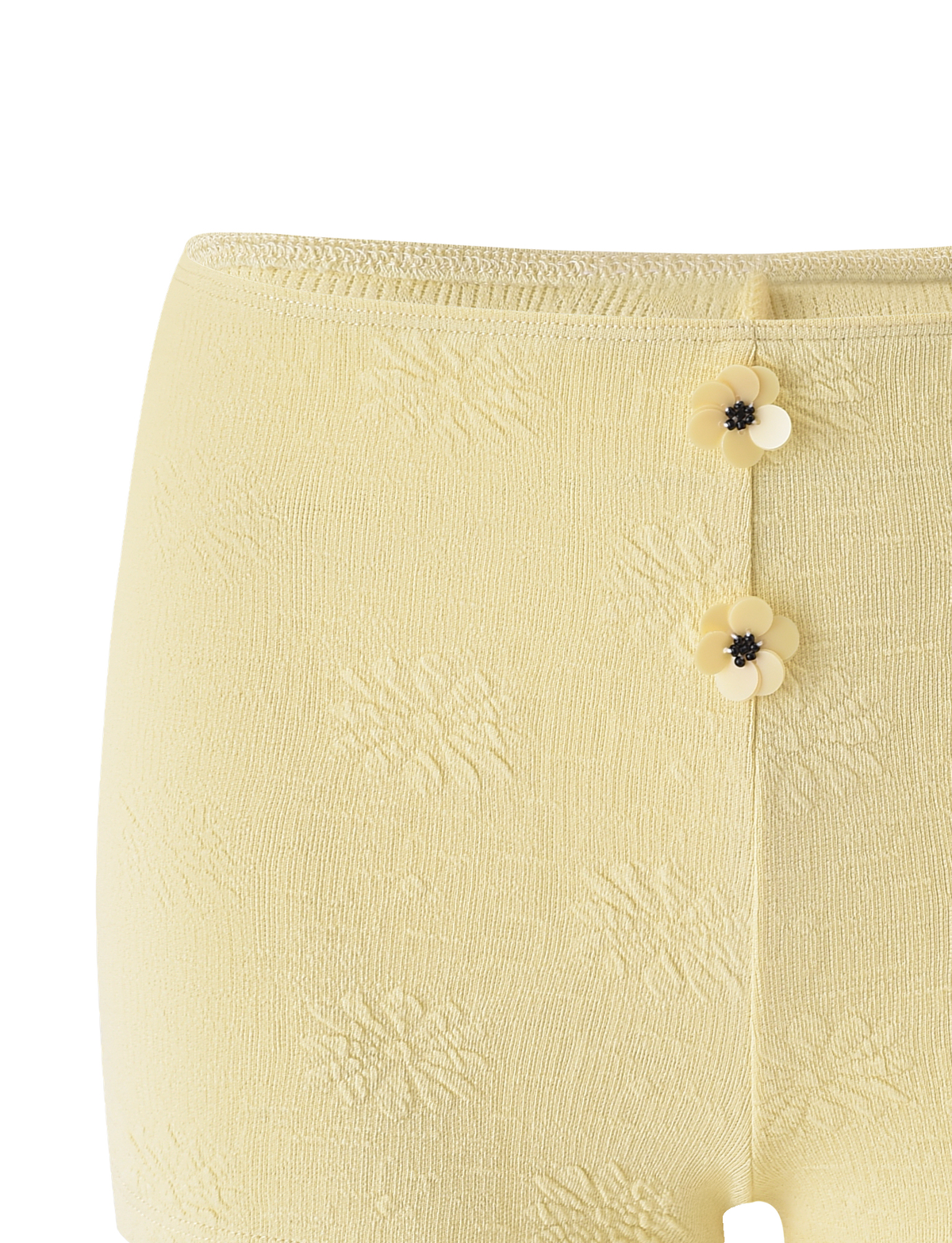 The TIGERMIST QUINLAN SHORT - LEMON features a light yellow hue, two front flower-shaped buttons, a subtle woven floral pattern, and charming flower accents.