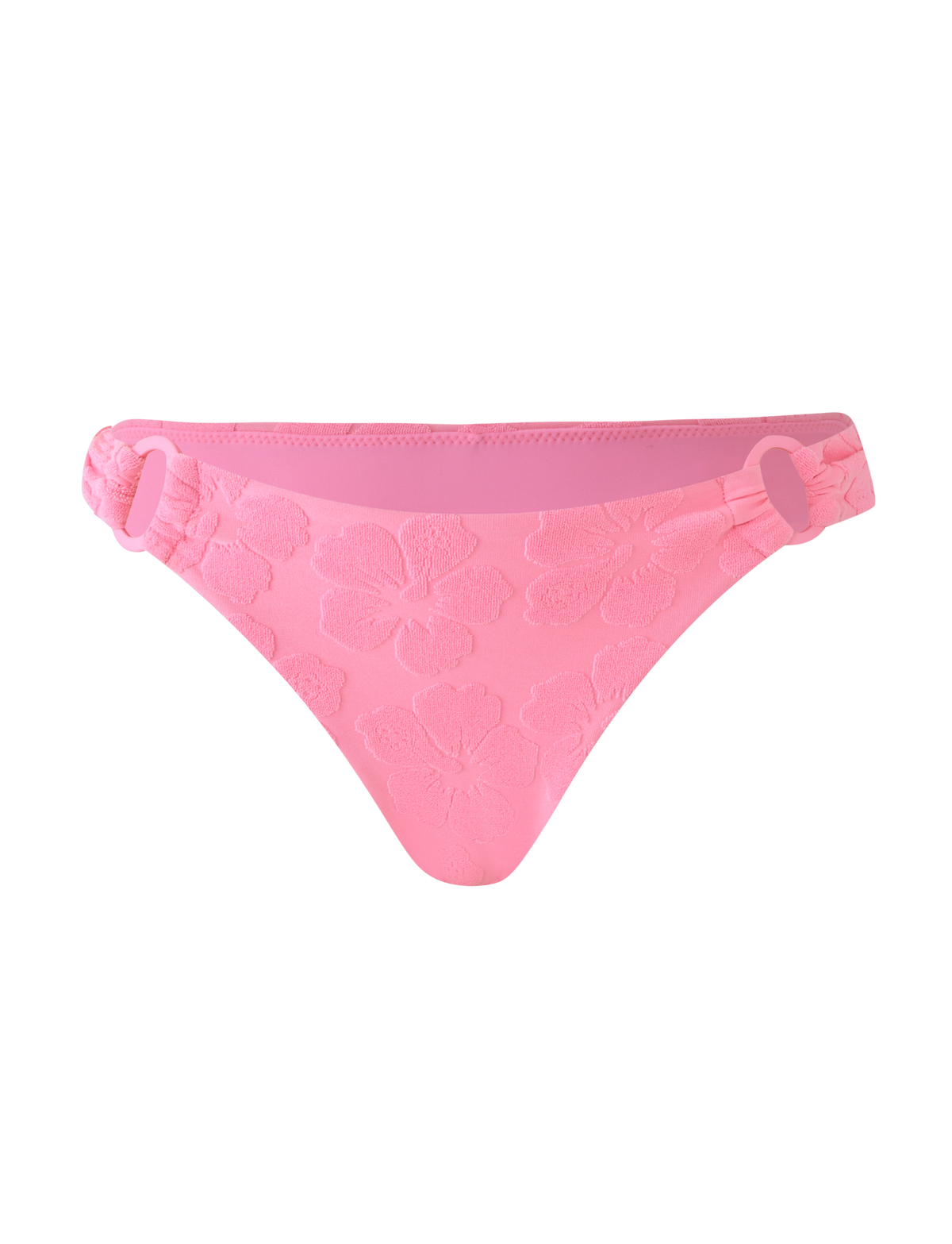 The FIORA BIKINI BOTTOM - BABY PINK by TIGERMIST features cheeky coverage, floral embossing, decorative side rings, and ruched sides, displayed on a matching pink background.