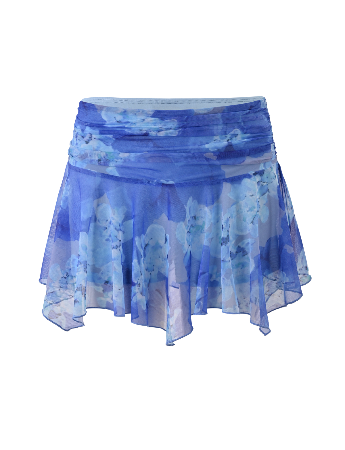 The DEVYN MINI SKORT by TIGERMIST features a flowy, sheer blue macro floral print, an asymmetrical handkerchief hemline, layered details, and a ruched waistband for a dreamy mid rise mini look.