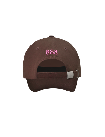 The MERRYN CAP - CHOCOLATE by TIGERMIST is a brown 5-panel hat with "888" embroidered in pink above the adjustable strap and metal buckle at the back.