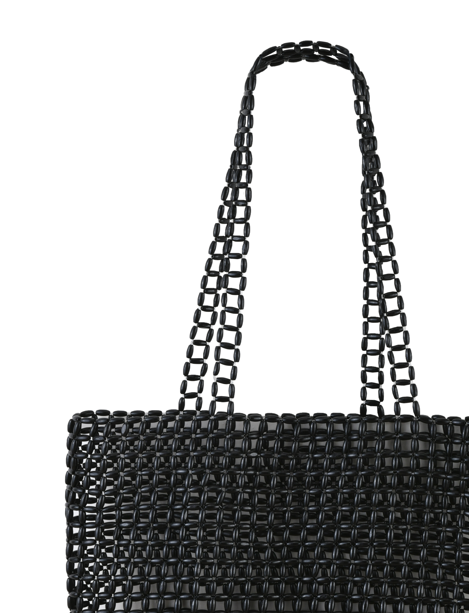 The LYNX BAG - BLACK by TIGERMIST is a large beaded tote with black beads in a grid-like open-weave design and two matching handles, shown against a plain white background.