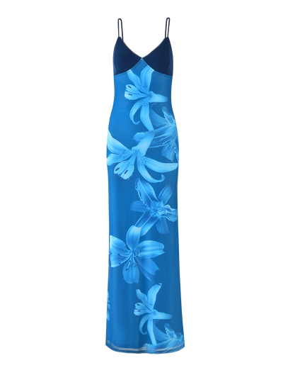 The ALAINA DRESS - BLUE ORCHID by TIGERMIST is a sleeveless, floor-length maxi dress featuring a V-neckline, adjustable spaghetti straps, and bold blue orchid prints—an elegant choice for any occasion.