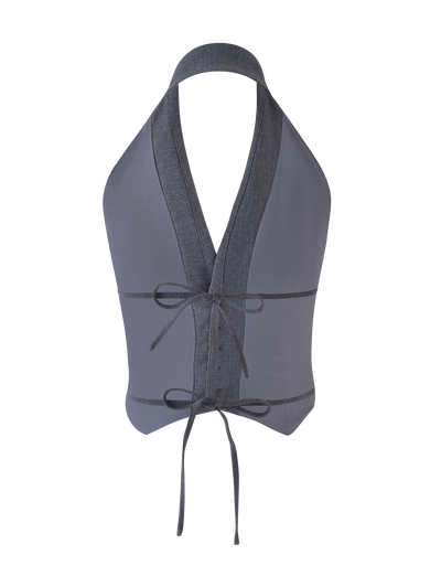 The FEDRA VEST - GREY by TIGERMIST is a gray, backless halter crop top with a tailored fit, deep V-neck, denim-like trim, and tie closures at the waist and neck.