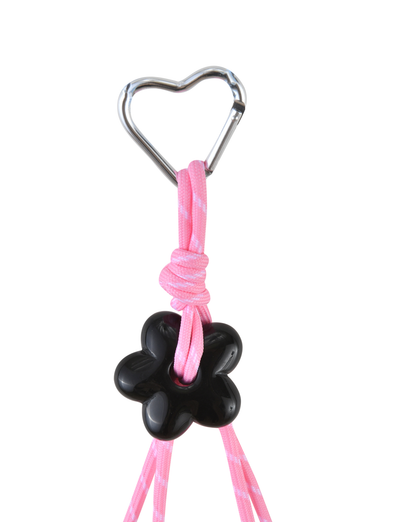 A heart-shaped clasp secures a hot pink cord looped through a black paw-shaped charm. The TIGERMIST MIRIAM KEYCHAIN - HOT PINK is shown against a white background.