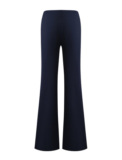The TIGERMIST GWENDOLINE PANT in navy is a high-waisted, ribbed knit flared leg pant, shown from the back on a white background.