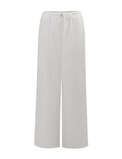 The TIGERMIST CRESSY PANT - WHITE features a full-length, loose wide-leg design with an elastic waistband and drawstring tie, shown on a plain white background.