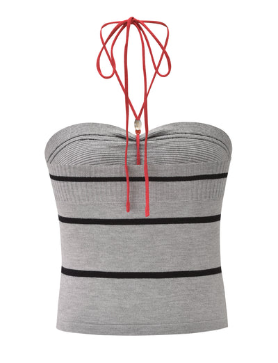 The NOUR TOP - GREY STRIPE by TIGERMIST is a fitted knit halter top with grey and black horizontal stripes, a red halter neck tie, and a chic strapless design.