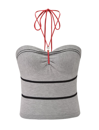 The NOUR TOP - GREY STRIPE by TIGERMIST is a stylish knit tube top with horizontal black stripes, a ruched front, and a red halter neck tie.